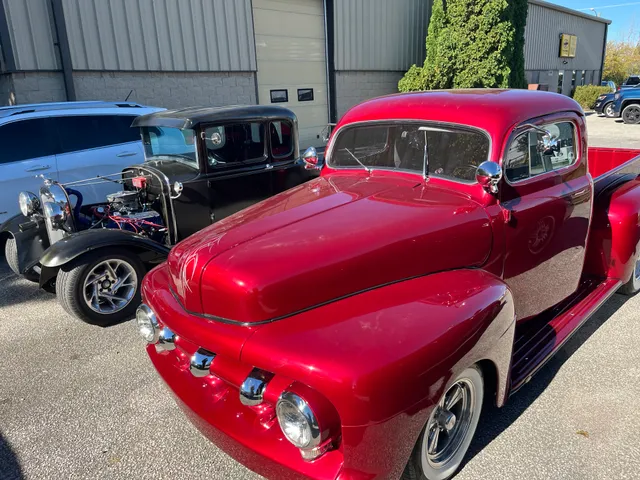 Classic vehicles outside the shop