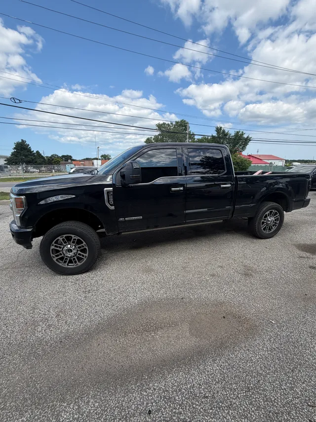 Black heavy-duty pickup outside the shop