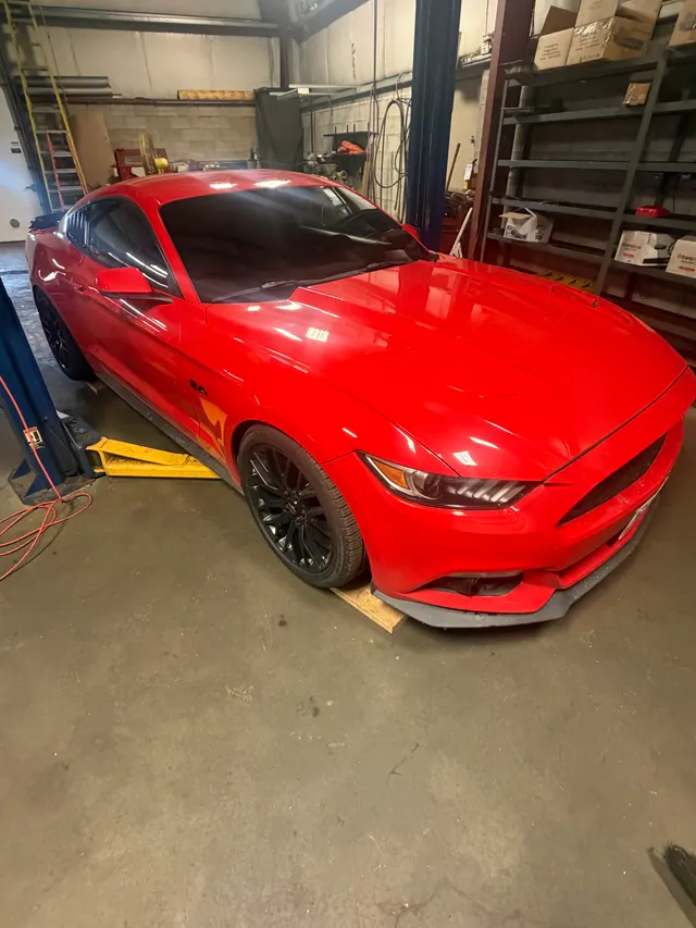 Red sports coupe inside the workshop
