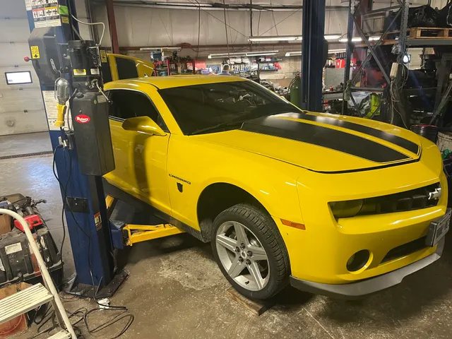 Yellow Camaro in the workshop